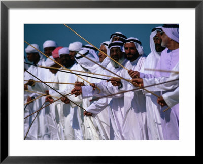 Men Performing Traditional Dance With Sticks, Abu Dhabi, United Arab Emirates by Chris Mellor Pricing Limited Edition Print image