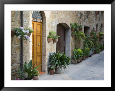 Flower Pots And Potted Plants Decorate A Narrow Street In Tuscan Village, Pienza, Italy by Dennis Flaherty Pricing Limited Edition Print image