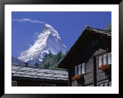 The Peak Of The Matterhorn Mountain Towering Above Chalet Rooftops, Swiss Alps, Switzerland by Ruth Tomlinson Pricing Limited Edition Print image