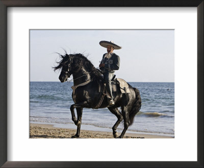 Horseman In Traditional Dress Riding Black Andalusian Stallion On Beach, Ojai, California, Usa by Carol Walker Pricing Limited Edition Print image