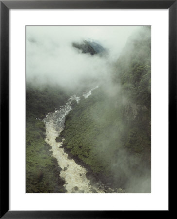 An Elevated View Of Mist-Shrouded Mountains And A Rushing River by Bill Curtsinger Pricing Limited Edition Print image