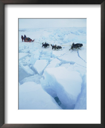 Huskies Carry A Sled Across Broken Ice During An Expedition Traversing The North Pole by Gordon Wiltsie Pricing Limited Edition Print image