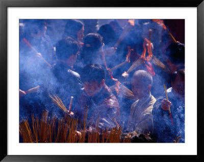 People Burning Incense At Wong Tai Sin Temple, Kowloon, Hong Kong, China by Lawrence Worcester Pricing Limited Edition Print image