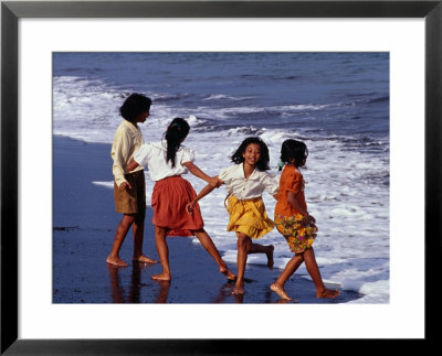 Girls On Lebih Beach, South Of Gianyar, Play Along The Fringe Of Breaking Waves, Indonesia by Adams Gregory Pricing Limited Edition Print image