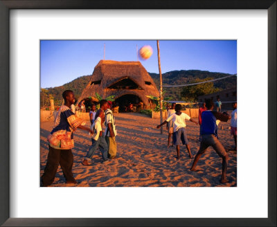 People Playing Volleyball Outside Indaba Bar, Cape Maclear, Malawi by Johnson Dennis Pricing Limited Edition Print image