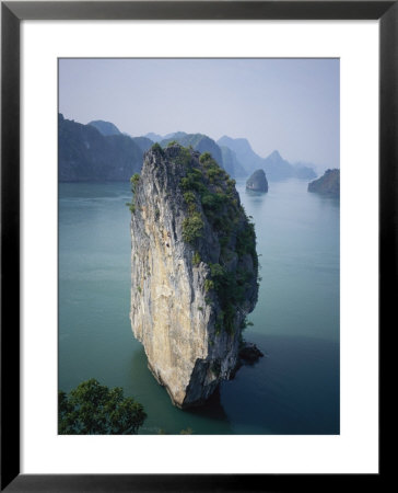 Karst Limestone Tower In Halong Bay, Vietnam by Bill Hatcher Pricing Limited Edition Print image
