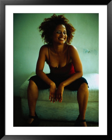 Woman Sitting On Bed, Smiling by Jeff Greenberg Pricing Limited Edition Print image