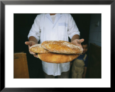 A Baker Shows His Fresh Loaves In The Village Bakery by Heather Perry Pricing Limited Edition Print image