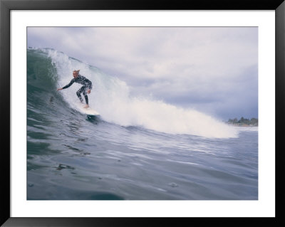 A Surfer Rides A Wave At Hammonds Beach by Rich Reid Pricing Limited Edition Print image