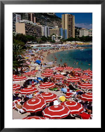 Overhead Of Red Sun Umbrellas At Larvotto Beach On Busy Summer's Day, Monte Carlo, Monaco by Dallas Stribley Pricing Limited Edition Print image