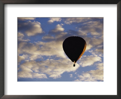 A Soaring Hot Air Balloon Against A Cloud-Filled Sky by Jason Edwards Pricing Limited Edition Print image
