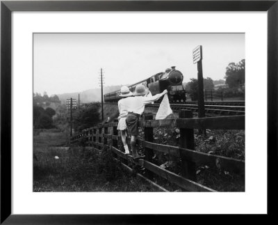 Two Children Stand On A Fence And Wave A Handkerchief At A Passing Steam Train by Staniland Pugh Pricing Limited Edition Print image