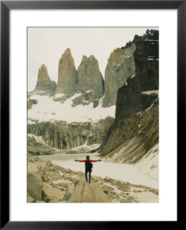 A Hiker With Outstretched Arms Is In Awe Of The Jagged Landscape by Skip Brown Pricing Limited Edition Print image
