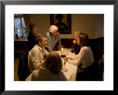 A Family Has A Fun Time Around A Table On Vacation, Fraueninsel, Chiemsee, Bavaria, Germany by Taylor S. Kennedy Pricing Limited Edition Print image