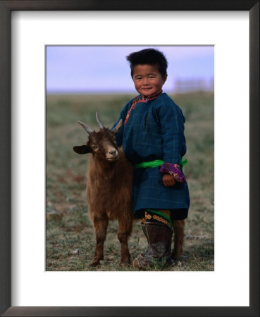 Boy Wearing Traditional Dell Standing Next To Baby Goat, Mongolia by Jerry Galea Pricing Limited Edition Print image