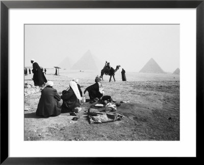 Camel Jockeys At The Giza Pyramids, Cairo, Egypt by Walter Bibikow Pricing Limited Edition Print image