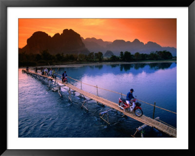 People Crossing Bridge Across Nam Song River By Motorbike, Vang Vieng, Laos by John Elk Iii Pricing Limited Edition Print image