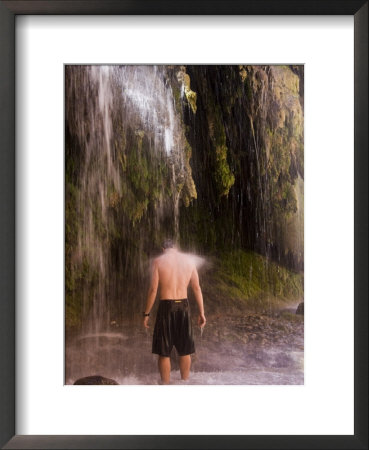 A Man Enjoys A Massage From A Waterfall by Taylor S. Kennedy Pricing Limited Edition Print image