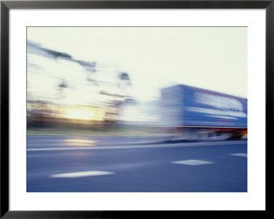 A Tractor Trailer Speeding Down A Highway At Sunset by Jason Edwards Pricing Limited Edition Print image