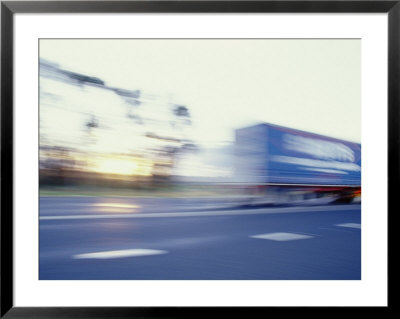 A Tractor Trailer Speeding Down A Highway At Sunset by Jason Edwards Pricing Limited Edition Print image