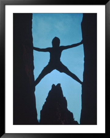 Silhouette Of Rock Climber Between Two Rocks by Chris Rogers Pricing Limited Edition Print image
