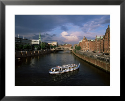 Excursion Boat On Canal In The Speicherstadt, The Historical Warehouse City Area, Hamburg, Germany by Yadid Levy Pricing Limited Edition Print image