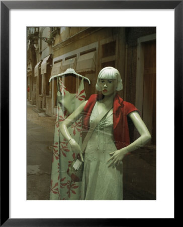 Mannequin In A Window That Is Reflecting The Store Fronts Across The Road by Todd Gipstein Pricing Limited Edition Print image