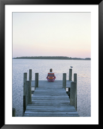 A Seagull Watches A Woman Practice Yoga On A Dock by Taylor S. Kennedy Pricing Limited Edition Print image