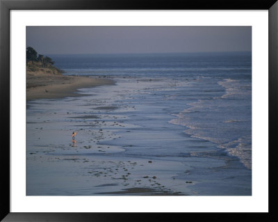 A Surfer Heads Towards The Water On Sands Beach by Rich Reid Pricing Limited Edition Print image