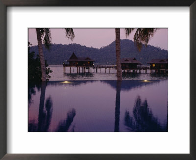 Reflections In A Pool And Traditional Malaysian Houses On Stilts by Eightfish Pricing Limited Edition Print image