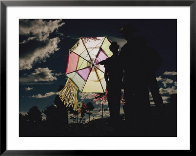 Several Men Hold A Kite That Is Backlit By The Sun by Joe Scherschel Pricing Limited Edition Print image
