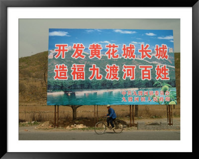 A Bicyclist Rides Past A Billboard by Richard Nowitz Pricing Limited Edition Print image