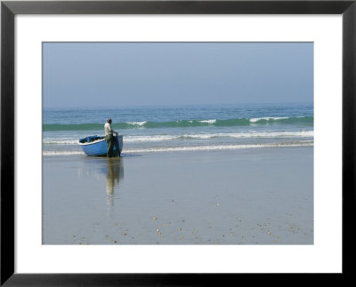 A Fisherman Waits For Help To Bring His Boat Back Up To The Beach by Heather Perry Pricing Limited Edition Print image