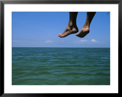 Sandy Feet Dangle Off The Side Of A Dock On Portsmouth Island by Stephen Alvarez Pricing Limited Edition Print image