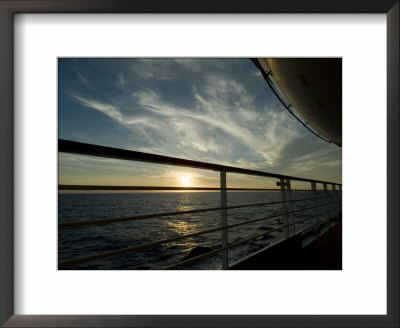Looking At Sunset Through The Railing On The Deck Of A Cruise Ship by Todd Gipstein Pricing Limited Edition Print image