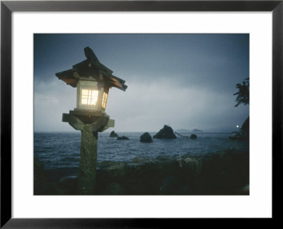 A Small Wooden Lantern Looks Out Over The Dark Sea by Luis Marden Pricing Limited Edition Print image