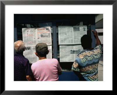 Men Reading The Daily Newspaper At An Inner City Kiosk, Havana, Cuba by Rick Gerharter Pricing Limited Edition Print image