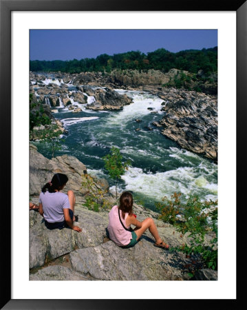 Girls Sitting On Rocks By Potomac River, Great Falls National Park, Usa by Mark & Audrey Gibson Pricing Limited Edition Print image