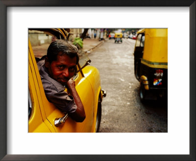 Taxi Driver Leaning Out Window As Motor Rickshaw Goes Past, Chowringee, India by Anthony Plummer Pricing Limited Edition Print image