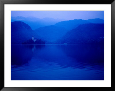 Mist Surrounds Church Of The Assumption On Blejski Otok (Bled Island) With Bled Castle, Slovenia by Richard I'anson Pricing Limited Edition Print image