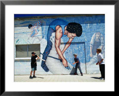 Boys Playing Cricket In Front Of Mural Wall On The Elliston Community Hall., Elliston, Australia by Greg Elms Pricing Limited Edition Print image