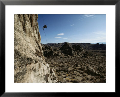 A Climber Rappels Down The Face Of A 150-Foot Rock Tower by Annie Griffiths Belt Pricing Limited Edition Print image