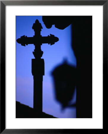 Cross And Lantern Silhouetted At Dusk, Rupit, Spain by Damien Simonis Pricing Limited Edition Print image
