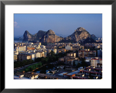 City Buildings And Limestone Karst Peaks In The Li River, Guilin, Guangxi, China by Richard I'anson Pricing Limited Edition Print image