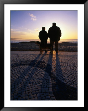 Two Men Watching Sunset Over Beach, Nazare, Portugal by Mason Florence Pricing Limited Edition Print image