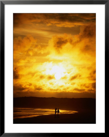 Couple In Silhouette On Beach Beneath Sunset, Isla Santa Cruz, Galapagos, Ecuador by Mark Newman Pricing Limited Edition Print image
