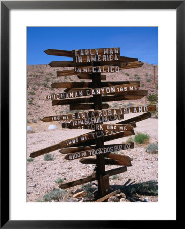 Sign Pointing In Many Directions, Mojave Desert, California, Usa by Stephen Saks Pricing Limited Edition Print image