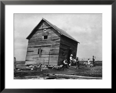 Ramshackle Barn With Farmer And Kids In Front Sharpening A Sickle Blade During Drought In Midwest by Margaret Bourke-White Pricing Limited Edition Print image