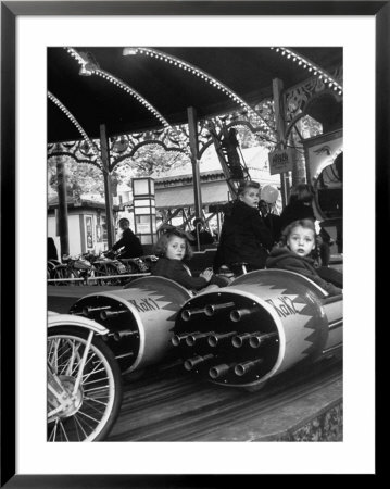 Children Waiting Expectantly For A Rocket Ride On The Carousel by Nina Leen Pricing Limited Edition Print image