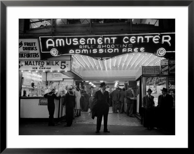 Sailors, Soldiers And Other Customers Standing Outside Of Neon Lit Amusement Arcade by Peter Stackpole Pricing Limited Edition Print image
